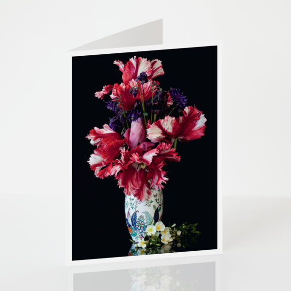 A vase containing exotic tulips combined with columbine and Dunwich Rose at its base